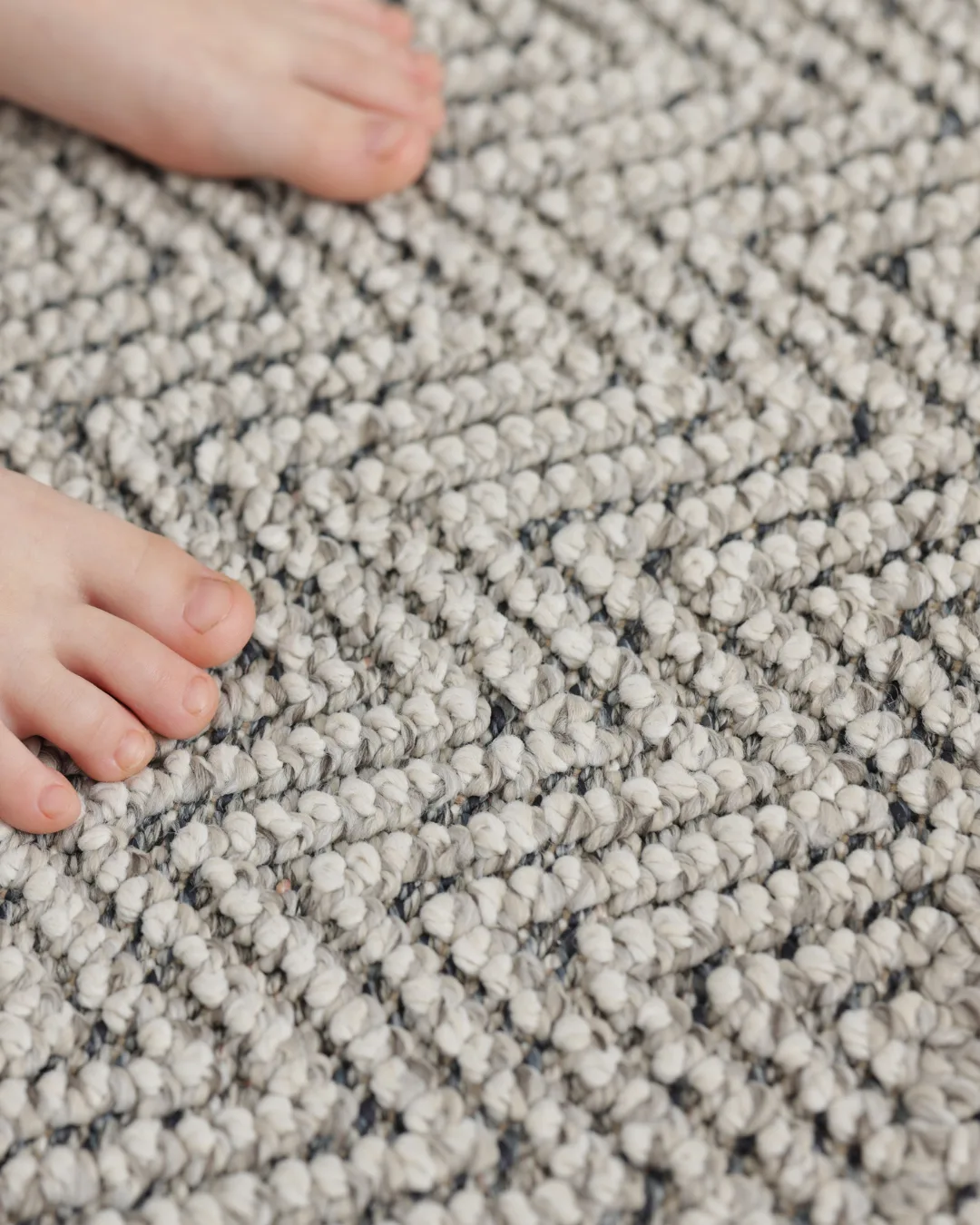 A baby's feet on soft, stain-resistant family-proof carpet in an Oklahoma City home