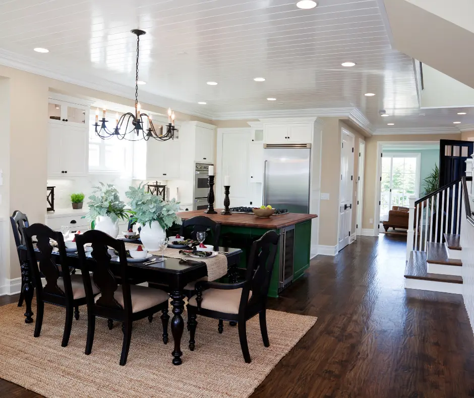 Dark wood-look floor running continuously through a dining area, kitchen and front hall
