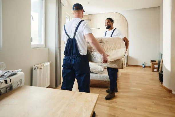 Floors To You crew carefully moving a homeowner’s sofa during a flooring install