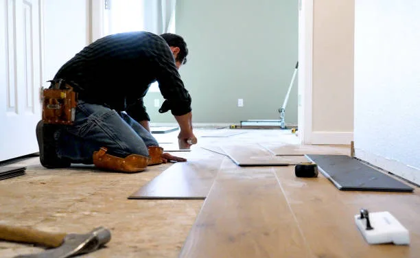 Floors To You installer fitting luxury vinyl plank flooring in an Oklahoma City home